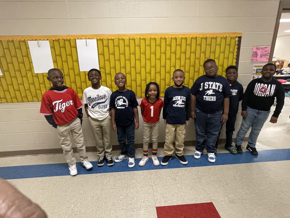 A group of kids standing in a classroomAI-generated content may be incorrect.